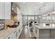 Open kitchen overlooking a dining area offers modern appliances and a spacious design at 7173 S Shady Grove Ct, Aurora, CO 80016