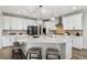 Spacious kitchen featuring a large center island, stainless appliances, and ample seating at 7173 S Shady Grove Ct, Aurora, CO 80016