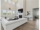 Bright living room featuring a fireplace, high ceilings, and an expansive sectional sofa at 7173 S Shady Grove Ct, Aurora, CO 80016