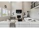 Stunning living room with a fireplace, soaring ceilings, and expansive sofa creating an inviting atmosphere at 7173 S Shady Grove Ct, Aurora, CO 80016