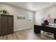 Office with dark wood desk, modern painting, and large window to allow natural light at 7173 S Shady Grove Ct, Aurora, CO 80016