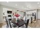 Open concept living room flows into a dining area and modern kitchen with a large island at 7173 S Shady Grove Ct, Aurora, CO 80016