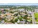 An aerial view depicts a house nestled in a green neighborhood with nearby shopping and community conveniences at 1655 Yates St, Denver, CO 80204