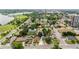 Aerial view of the neighborhood showcasing tree-lined streets, lush greenery, and proximity to a lake at 1655 Yates St, Denver, CO 80204