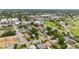 An aerial view shows a green neighborhood featuring a charming house conveniently located near shopping and other amenities at 1655 Yates St, Denver, CO 80204