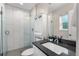 Bathroom with modern features, stylish vanity, a glass-enclosed shower, and great lighting at 1655 Yates St, Denver, CO 80204