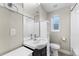 Cozy bathroom with a single sink vanity, tile flooring, and shower with a curtain at 1655 Yates St, Denver, CO 80204