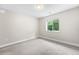 Large empty bedroom features neutral walls, carpet, and a bright window at 1655 Yates St, Denver, CO 80204