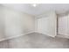 Spacious empty bedroom with carpet, neutral walls, bi-fold closet doors, and bright lighting at 1655 Yates St, Denver, CO 80204
