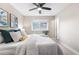 Bedroom with neutral paint, ceiling fan, comfortable bed, and lots of natural light at 1655 Yates St, Denver, CO 80204