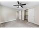 Bedroom with ceiling fan, carpet, neutral walls, and white closet door and trim at 1655 Yates St, Denver, CO 80204