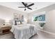 Bright bedroom with neutral paint, ceiling fan, comfortable bed, and lots of natural light at 1655 Yates St, Denver, CO 80204
