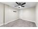 Bedroom with ceiling fan, neutral carpet and walls and a white door to closet at 1655 Yates St, Denver, CO 80204