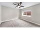 Vacant bedroom with a modern ceiling fan, large window and carpet at 1655 Yates St, Denver, CO 80204
