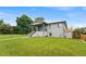 Beautifully landscaped front yard featuring lush green lawn and walkway leading to the charming two-story home at 1655 Yates St, Denver, CO 80204