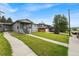 Charming home with well-manicured lawn and walkway leading to the front door, next to another house at 1655 Yates St, Denver, CO 80204