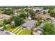 A well-maintained gray home on a green lawn offers a beautiful exterior with mature trees and a three-car driveway at 1655 Yates St, Denver, CO 80204