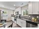 Updated kitchen boasts stainless steel appliances, gray backsplash, and ample counter space at 1655 Yates St, Denver, CO 80204