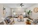 Cozy living room with neutral paint, ceiling fan, stylish seating, and lots of natural light at 1655 Yates St, Denver, CO 80204