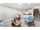 Open-concept living area with a kitchenette, stairs, and neutral decor at 1655 Yates St, Denver, CO 80204