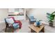 Bright living area featuring a kitchenette, stairs, neutral walls, and warm lighting at 1655 Yates St, Denver, CO 80204