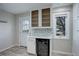 Updated kitchen with white cabinets and a wine cooler at 8978 W Dartmouth Pl, Lakewood, CO 80227