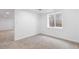 A basement bedroom with neutral carpet and a window at 4257 S Andes Way, Aurora, CO 80013