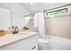 Bright bathroom with a large mirror and tiled bath/shower combo at 4257 S Andes Way, Aurora, CO 80013