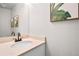 Bathroom with a modern sink, mirror, and stylish artwork at 4257 S Andes Way, Aurora, CO 80013
