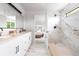 Modern bathroom featuring dual vanities, an oversized shower, and updated fixtures at 4257 S Andes Way, Aurora, CO 80013