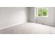This is a bright bedroom with neutral carpet and a window at 4257 S Andes Way, Aurora, CO 80013