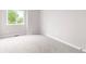 Bright bedroom featuring a window and neutral carpet at 4257 S Andes Way, Aurora, CO 80013