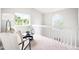 Open hallway with sitting area and view of stairs down to the living room at 4257 S Andes Way, Aurora, CO 80013