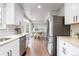 Bright kitchen with white cabinets, stainless steel appliances and an open layout at 4257 S Andes Way, Aurora, CO 80013