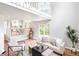 Bright living room featuring an open staircase and view of the dining area at 4257 S Andes Way, Aurora, CO 80013