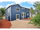 Blue two-story house with white trim surrounded by red mulch and gravel landscaping at 4257 S Andes Way, Aurora, CO 80013