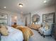 Serene bedroom featuring a decorative mirror, soft textures, and a cozy armchair for a peaceful retreat at 21945 E 51St Dr, Aurora, CO 80019