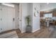 Bright entry foyer featuring wood floors, a white front door, and view into the kitchen at 21945 E 51St Dr, Aurora, CO 80019