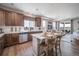 Well-lit kitchen features an island with seating, wood cabinets, and stainless steel appliances at 21945 E 51St Dr, Aurora, CO 80019