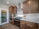 Modern kitchen featuring stainless steel appliances, wood cabinets, and a pantry at 21945 E 51St Dr, Aurora, CO 80019