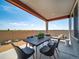 Covered patio with dining table, outdoor seating, and views of the expansive yard and open landscape at 21945 E 51St Dr, Aurora, CO 80019