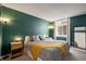 Main bedroom with dark-green accent wall and a king-size bed at 3353 S Monaco Pkwy # A, Denver, CO 80222