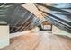 View of unfinished attic space featuring plywood flooring and exposed beams at 3427 W 29Th Ave, Denver, CO 80211