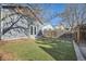 Well-maintained backyard with lush green grass, stepping stones, and a detached garage with painted siding at 3427 W 29Th Ave, Denver, CO 80211