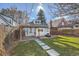 Backyard featuring a pergola with a brick patio, fire pit, and stepping stones leading to the house at 3427 W 29Th Ave, Denver, CO 80211