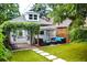 Outdoor living space with lush landscaping, patio, furniture, and stepping stones leading to the lawn at 3427 W 29Th Ave, Denver, CO 80211
