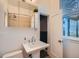 Updated bathroom with pedestal sink, medicine cabinet, and natural light at 3427 W 29Th Ave, Denver, CO 80211