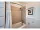 Bright bathroom features tiled walls and a shower-tub combination and an art niche at 3427 W 29Th Ave, Denver, CO 80211