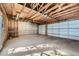 View of an open garage with unfinished walls and exposed rafters at 3427 W 29Th Ave, Denver, CO 80211
