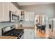 Well-lit kitchen with granite countertops, stainless steel appliances, and modern white cabinetry at 3427 W 29Th Ave, Denver, CO 80211